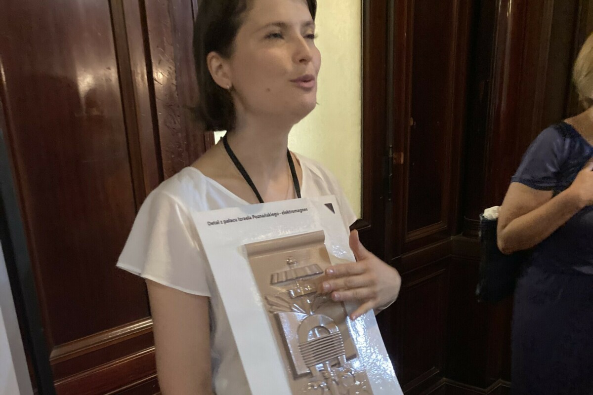 A woman holding a replica relief made of plastic in her hands