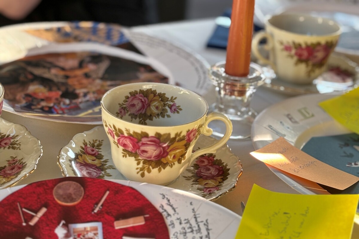 Tisch mit Sammeltassen, Kerzen und Materialien zu dem Projekt "Unser Leben sei ein Fest!"